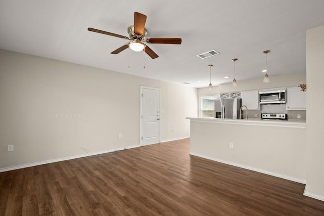 4603 Englewood Dr, Austin, TX 78745 - unfurnished living room featuring ceiling fan, dark wood-style floors, a sink, and baseboards