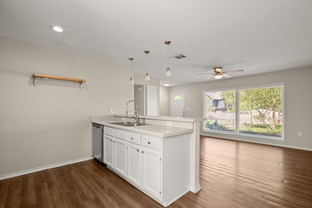 4603 Englewood Dr, Austin, TX 78745 - kitchen featuring a peninsula, white cabinetry, dark wood finished floors, a ceiling fan, and stainless steel dishwasher
