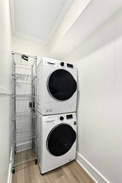 2122 Hancock Dr Unit 103, Austin, TX 78756 - washroom with estacked washer and dryer and light wood-style flooring