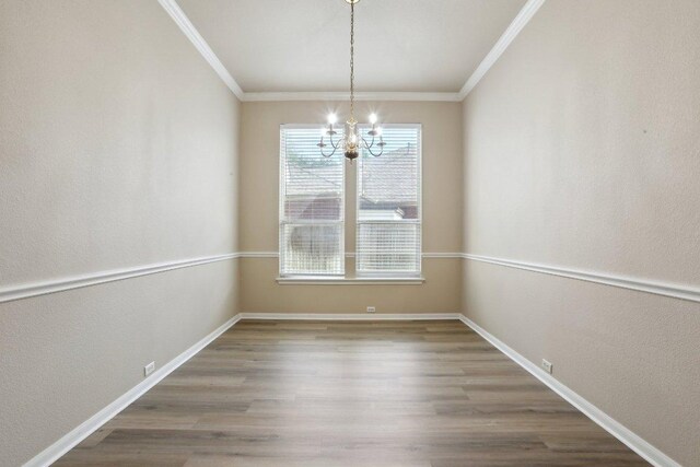 8400 Fern Bluff Ave, Round Rock, TX 78681 - unfurnished dining area featuring a chandelier, ornamental molding, wood finished floors, and baseboards