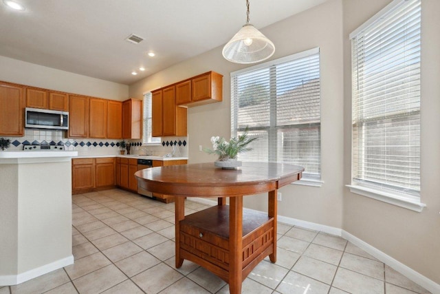 8400 Fern Bluff Ave, Round Rock, TX 78681 - kitchen with appliances with stainless steel finishes, light countertops, plenty of natural light, light tile patterned flooring, and recessed lighting
