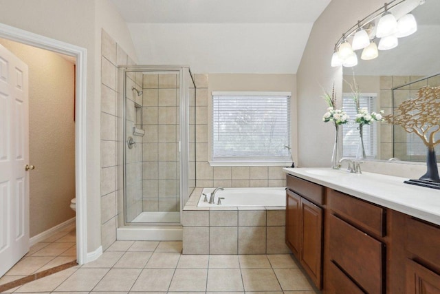 bathroom with tile patterned floors, a stall shower, vanity, a garden tub, and toilet
