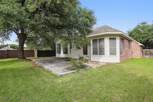 back of house featuring brick siding and a deck
