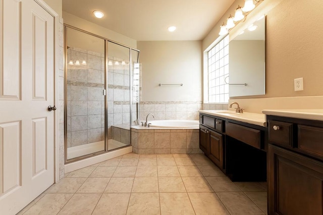 bathroom featuring a bath, a stall shower, tile patterned floors, vanity, and recessed lighting