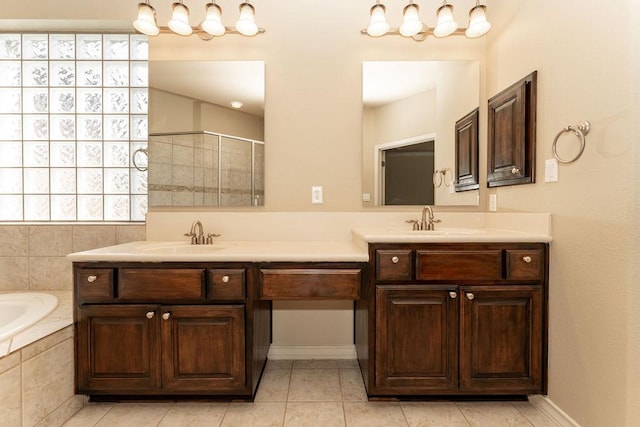 bathroom with a bath, a tile shower, and double vanity