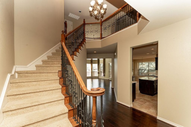 604 Riley Trl, Cedar Park, TX 78613 - stairway with wood-type flooring, a chandelier, and baseboards