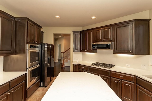 604 Riley Trl, Cedar Park, TX 78613 - kitchen with stainless steel appliances, light countertops, dark brown cabinets, and recessed lighting