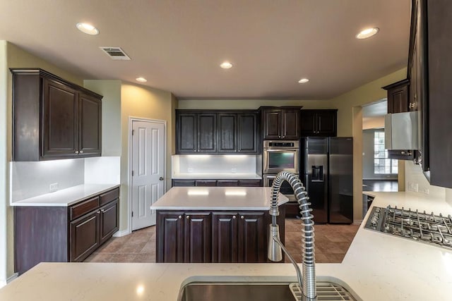 604 Riley Trl, Cedar Park, TX 78613 - kitchen featuring appliances with stainless steel finishes, light countertops, dark brown cabinets, a sink, and recessed lighting