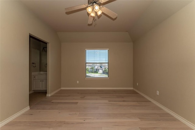 unfurnished bedroom featuring light wood-style flooring, ensuite bath, baseboards, and ceiling fan