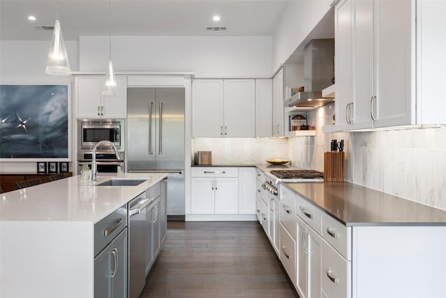 2500 Cedarview Dr, Austin, TX 78704 - kitchen with built in appliances, dark wood-style flooring, tasteful backsplash, white cabinets, and pendant lighting