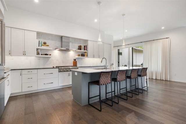 2500 Cedarview Dr, Austin, TX 78704 - kitchen featuring wall chimney exhaust hood, stainless steel gas cooktop, open shelves, decorative backsplash, and recessed lighting
