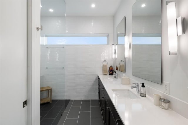2500 Cedarview Dr, Austin, TX 78704 - bathroom featuring tile patterned flooring, double vanity, recessed lighting, and tile walls