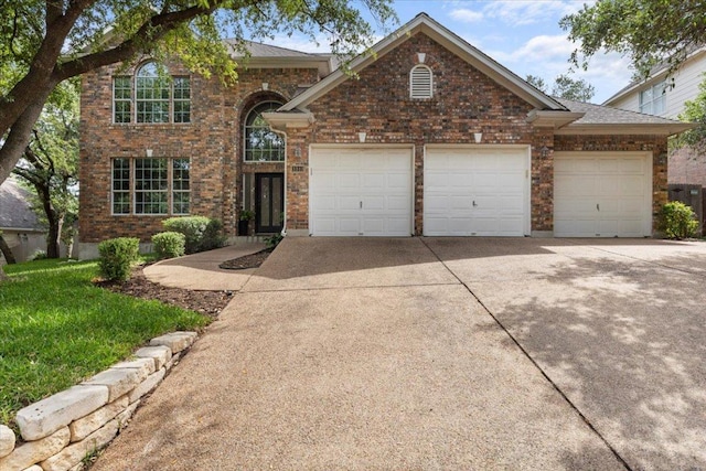 3313 Oxsheer Dr, Austin, TX 78732 - traditional-style home featuring a garage, concrete driveway, brick siding, and a front lawn