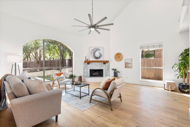 3313 Oxsheer Dr, Austin, TX 78732 - living area featuring ceiling fan, plenty of natural light, high vaulted ceiling, light wood finished floors, and a fireplace