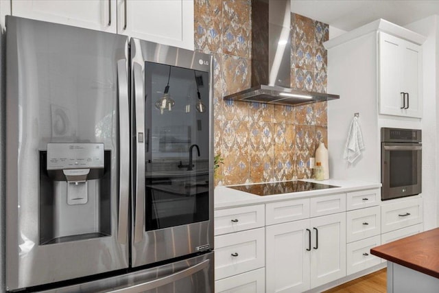 3313 Oxsheer Dr, Austin, TX 78732 - kitchen with stainless steel refrigerator with ice dispenser, wall oven, wall chimney exhaust hood, black electric cooktop, and backsplash