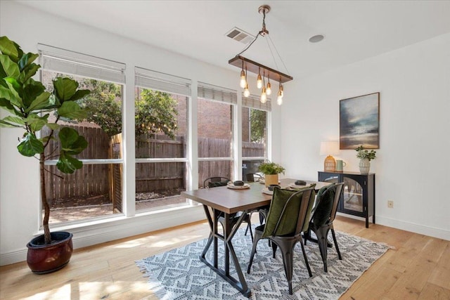 3313 Oxsheer Dr, Austin, TX 78732 - dining room with a chandelier, hardwood / wood-style flooring, lofted ceiling, and baseboards