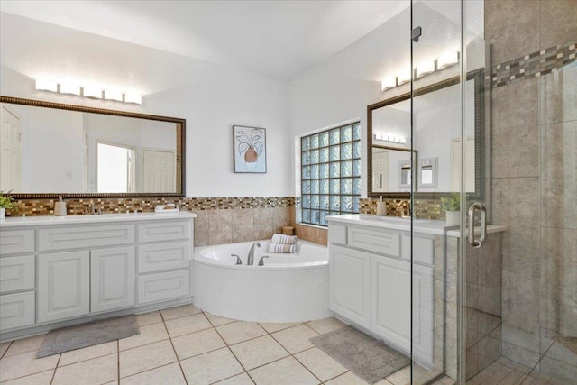 3313 Oxsheer Dr, Austin, TX 78732 - bathroom with a stall shower, a bath, tile patterned flooring, vanity, and tile walls