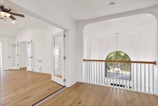 3313 Oxsheer Dr, Austin, TX 78732 - foyer entrance featuring wood finished floors, a ceiling fan, arched walkways, baseboards, and vaulted ceiling