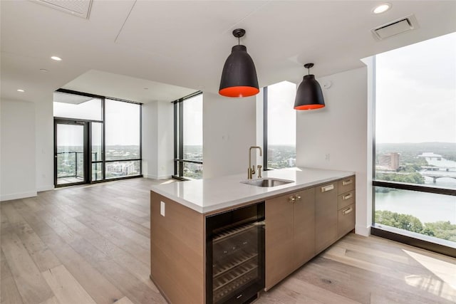 kitchen with a sink, wine cooler, plenty of natural light, and recessed lighting