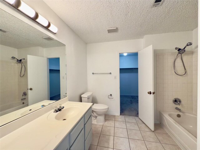 7817 Marble Ridge Dr, Austin, TX 78747 - full bath featuring tub / shower combination, vanity, toilet, tile patterned floors, and a textured ceiling