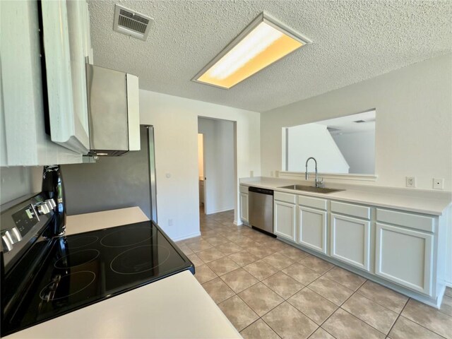 7817 Marble Ridge Dr, Austin, TX 78747 - kitchen with electric stove, dishwasher, a sink, light countertops, and a textured ceiling