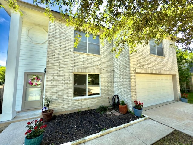 7817 Marble Ridge Dr, Austin, TX 78747 - view of front of home with a garage, brick siding, and driveway