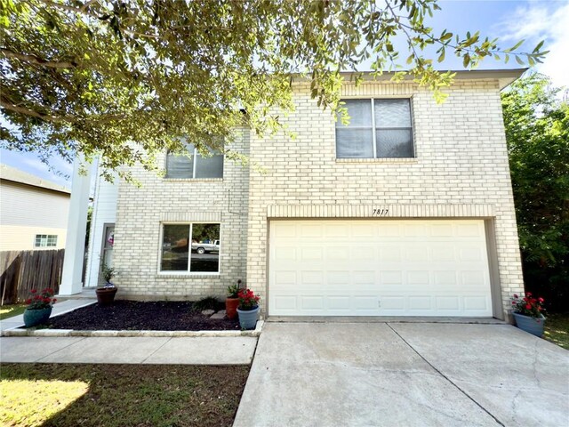 7817 Marble Ridge Dr, Austin, TX 78747 - view of front of home featuring brick siding, driveway, and an attached garage