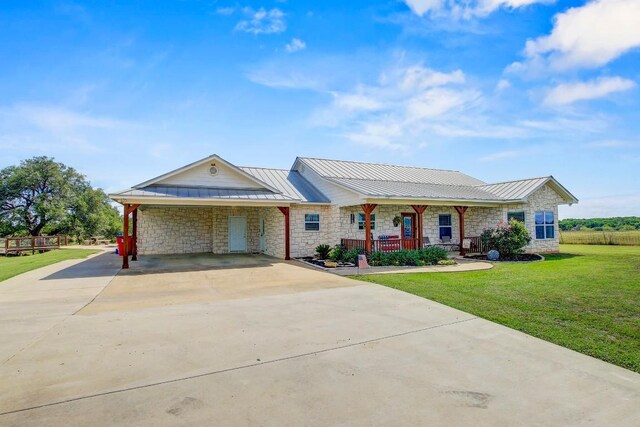 603 Watterson Rd Unit B, Bastrop, TX 78602 - ranch-style house featuring a standing seam roof, a porch, stone siding, and a front yard