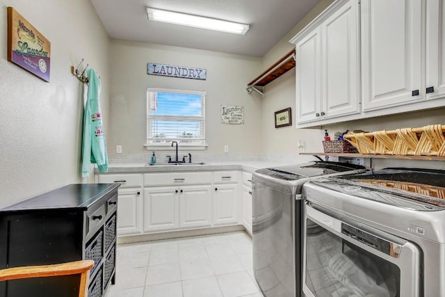 603 Watterson Rd Unit B, Bastrop, TX 78602 - washroom featuring independent washer and dryer, cabinet space, and light tile patterned floors