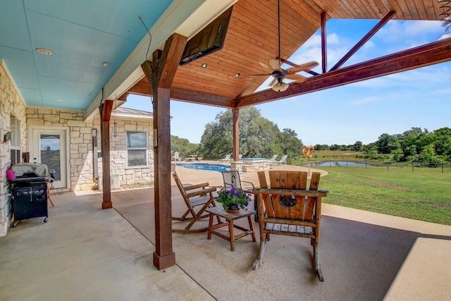 603 Watterson Rd Unit B, Bastrop, TX 78602 - view of patio / terrace featuring a water view, a ceiling fan, an outdoor pool, and grilling area