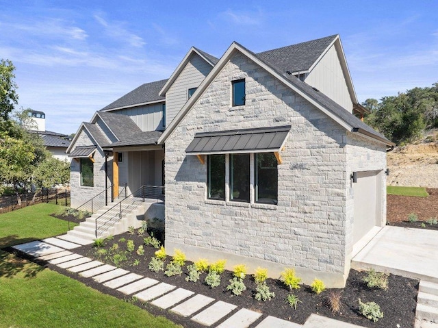 view of front of home with stone siding, a garage, and concrete driveway
