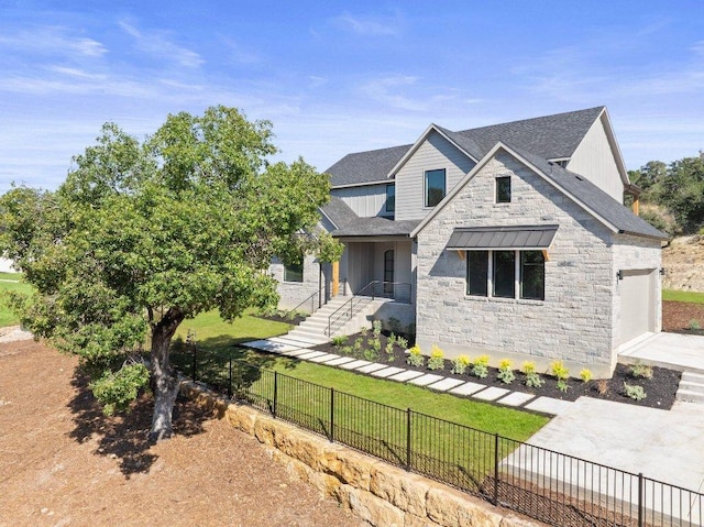 view of front of property with stone siding, a garage, roof with shingles, driveway, and board and batten siding