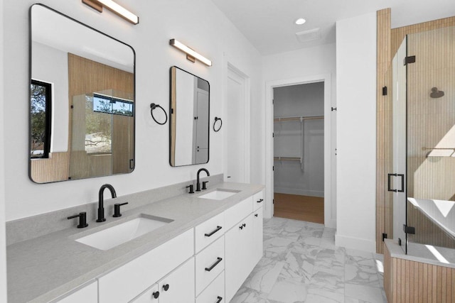 19634 Thurman Bend Rd, Spicewood, TX 78669 - bathroom with marble look tiles, double vanity, a shower stall, a spacious closet, and recessed lighting