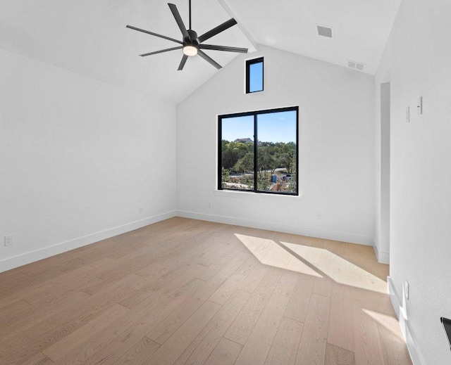 19634 Thurman Bend Rd, Spicewood, TX 78669 - empty room with a ceiling fan, light wood-style floors, beamed ceiling, and high vaulted ceiling