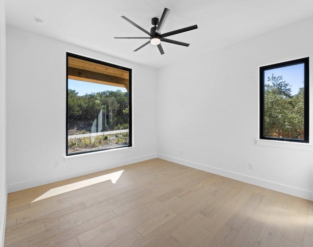 19634 Thurman Bend Rd, Spicewood, TX 78669 - unfurnished room featuring light wood-style flooring, a ceiling fan, and a smoke detector