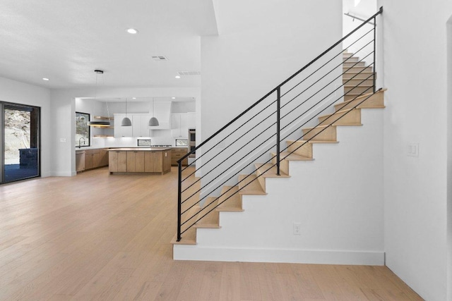 19634 Thurman Bend Rd, Spicewood, TX 78669 - stairway featuring wood finished floors and recessed lighting