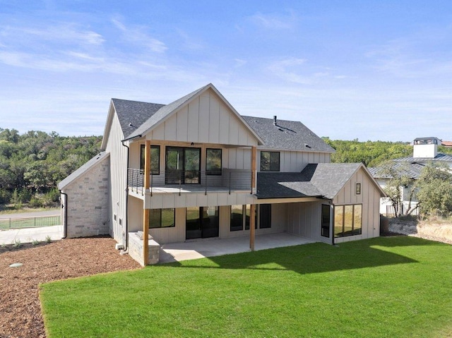 19634 Thurman Bend Rd, Spicewood, TX 78669 - rear view of property with board and batten siding, roof with shingles, a yard, and a patio area