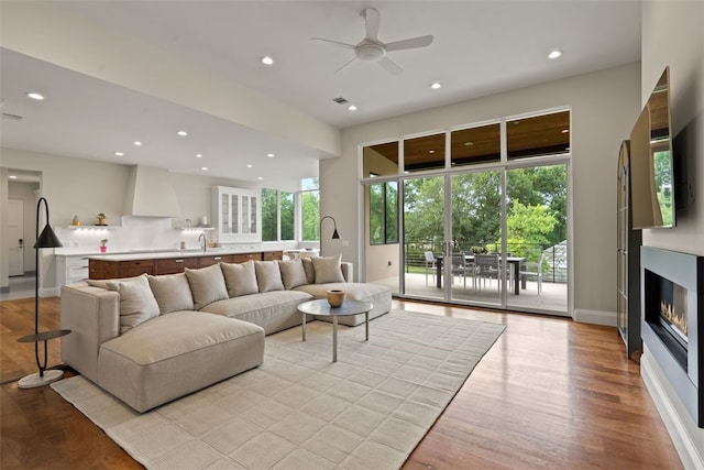 302 Bent Tree Ct, West Lake Hills, TX 78746 - living area featuring a ceiling fan, recessed lighting, a glass covered fireplace, plenty of natural light, and light wood finished floors