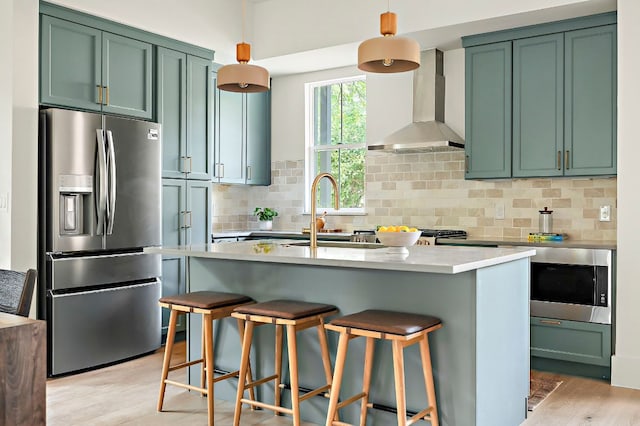 1406 Cometa St Unit 1, Austin, TX 78721 - kitchen with appliances with stainless steel finishes, wall chimney exhaust hood, green cabinets, and a sink