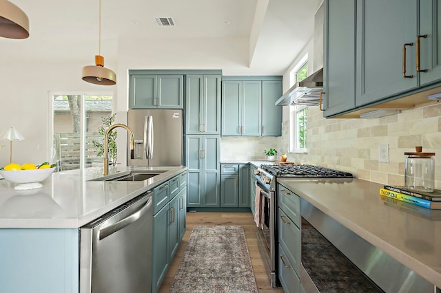 1406 Cometa St Unit 1, Austin, TX 78721 - kitchen featuring stainless steel appliances, extractor fan, a sink, backsplash, and light wood-style floors