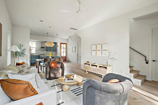 1406 Cometa St Unit 1, Austin, TX 78721 - living area featuring stairway, a ceiling fan, light wood-style flooring, and baseboards
