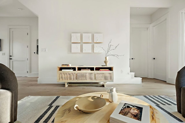 1406 Cometa St Unit 1, Austin, TX 78721 - living room featuring wood finished floors, baseboards, and stairway
