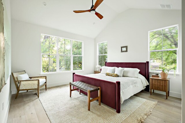 1406 Cometa St Unit 1, Austin, TX 78721 - bedroom with light wood finished floors, ceiling fan, high vaulted ceiling, and baseboards