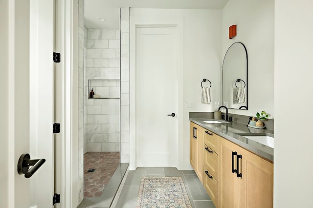 1406 Cometa St Unit 1, Austin, TX 78721 - bathroom featuring a tile shower, tile patterned floors, and double vanity