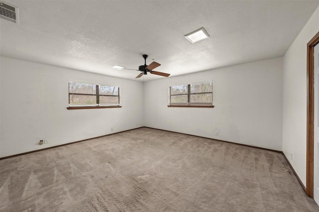 2821 Creek Side Dr, Temple, TX 76502 - empty room featuring carpet, healthy amount of natural light, ceiling fan, a textured ceiling, and baseboards