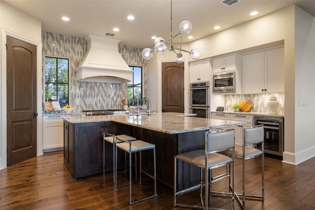 308 Duckhorn Pass, Austin, TX 78738 - kitchen with wine cooler, custom range hood, dark wood-style floors, a sink, and recessed lighting