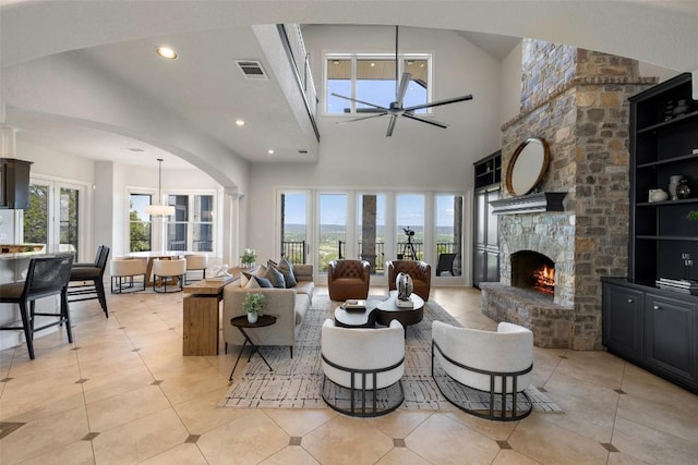 1071 Escalar Dr, Buchanan Dam, TX 78609 - living area featuring a ceiling fan, recessed lighting, a stone fireplace, light tile patterned floors, and arched walkways