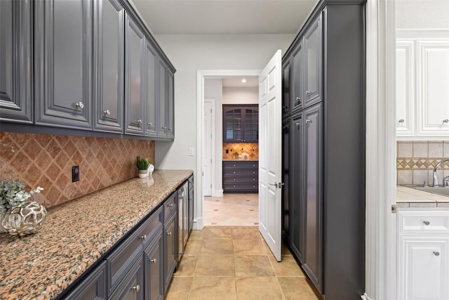 1071 Escalar Dr, Buchanan Dam, TX 78609 - kitchen featuring backsplash, a sink, stone counters, light tile patterned flooring, and recessed lighting
