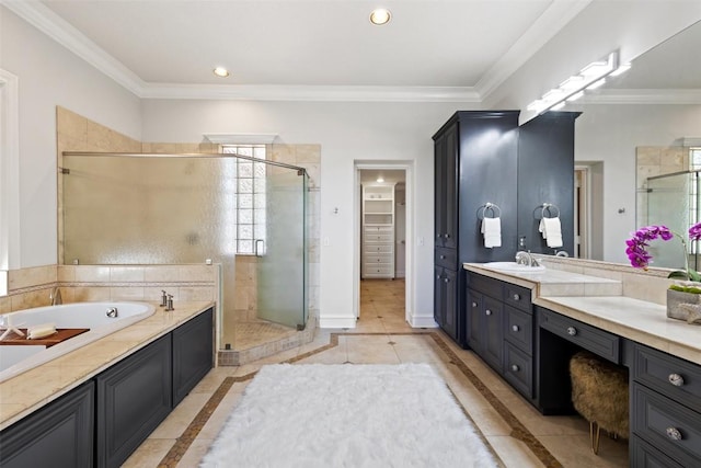 1071 Escalar Dr, Buchanan Dam, TX 78609 - full bathroom with inlaid floor details, a shower stall, a garden tub, vanity, and ornamental molding