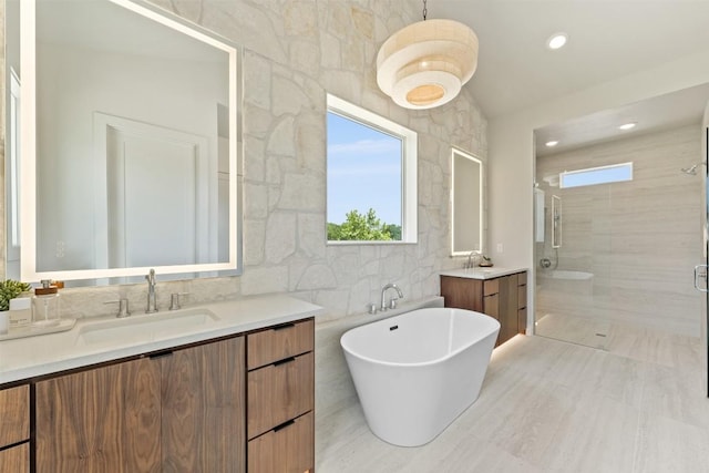 298 Glenview Cir, Belton, TX 76513 - bathroom with a stall shower, a freestanding tub, two vanities, and recessed lighting